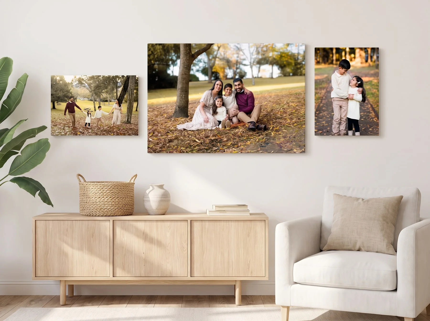 Three canvases from one autumn family session hung as a cluster above a timber sideboard