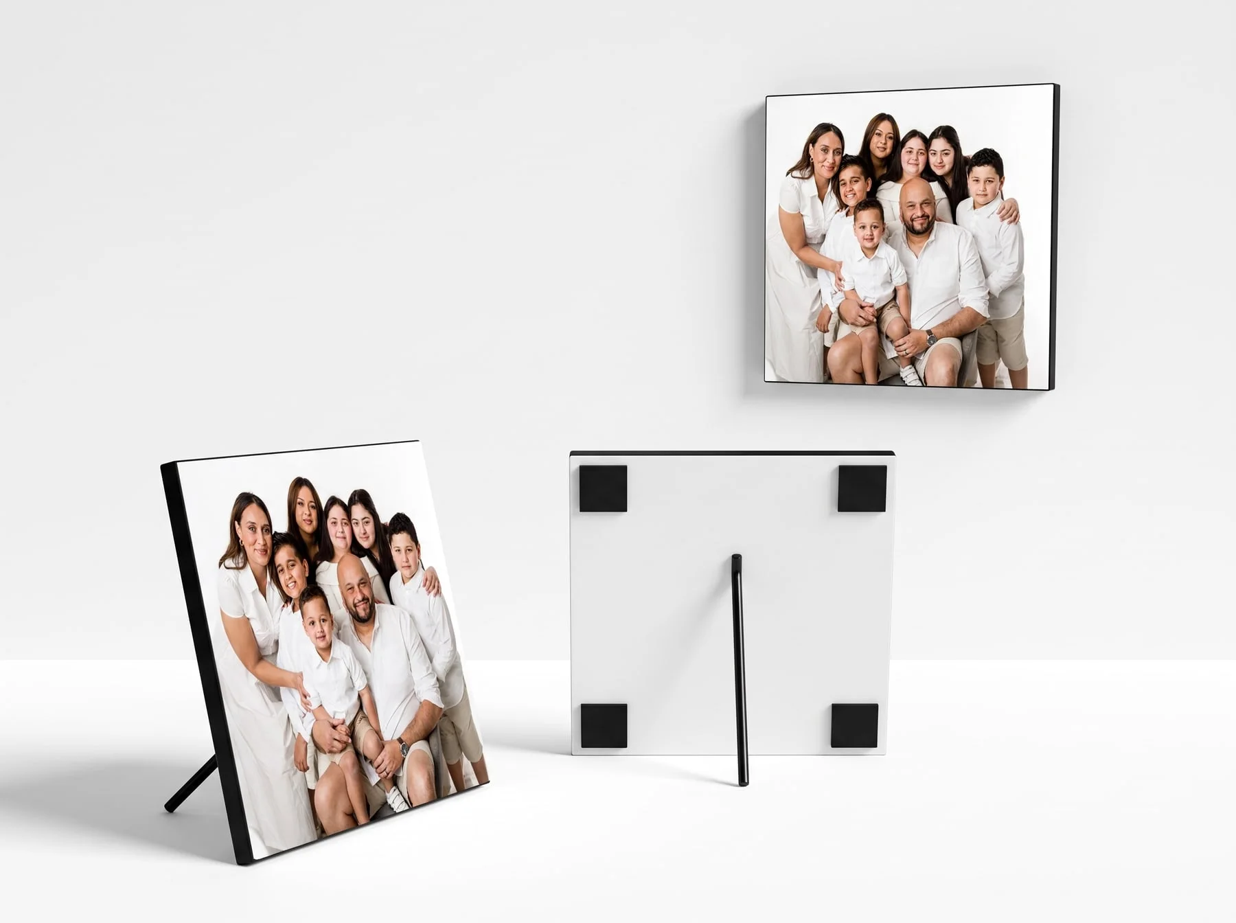 A Faithful Photography photoblock shown three ways — mounted on the wall, standing on a surface, and from behind showing its adhesive pads and support rod
