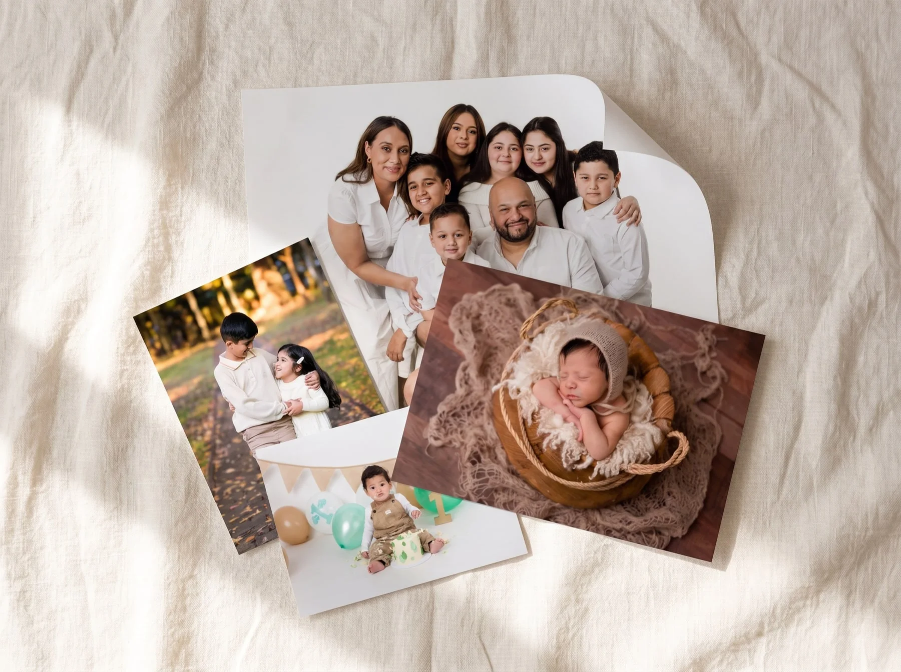 Faithful Photography matte photographic prints in four sizes, laid overlapping on linen